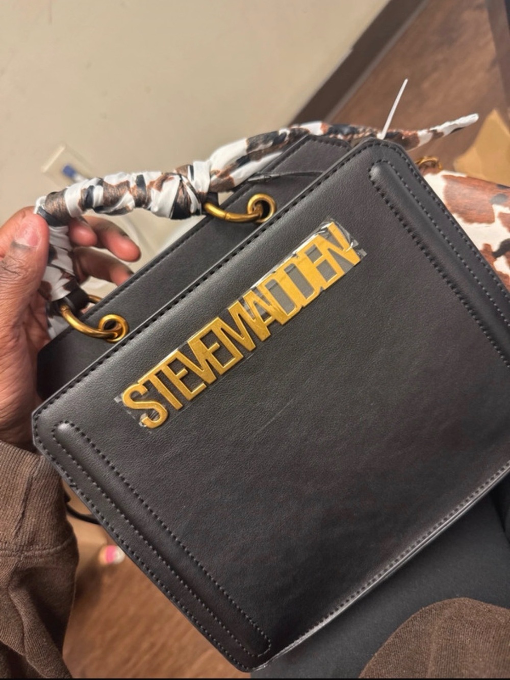 Steve Madden Black Crossbody Bag with Gold Logo and Scarf-Wrapped Handle